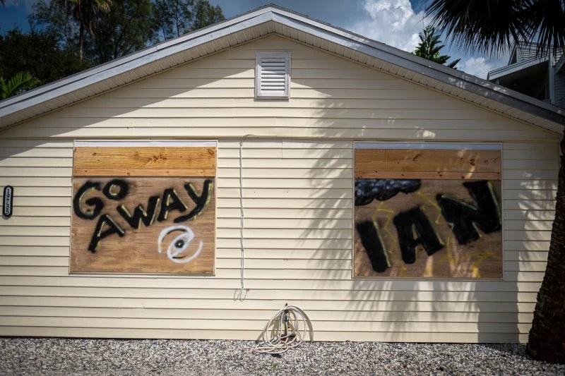 A house is boarded up ahead