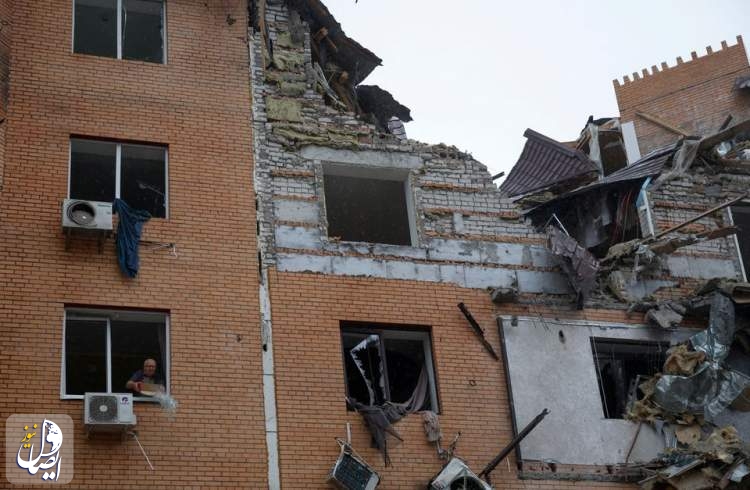 A local man throws debris out of a broken window in a residential building heavily damaged by a Russian missile attack in Mykolaiv, Ukraine October 23, 2022.