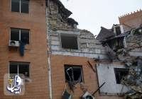 A local man throws debris out of a broken window in a residential building heavily damaged by a Russian missile attack in Mykolaiv, Ukraine October 23, 2022.